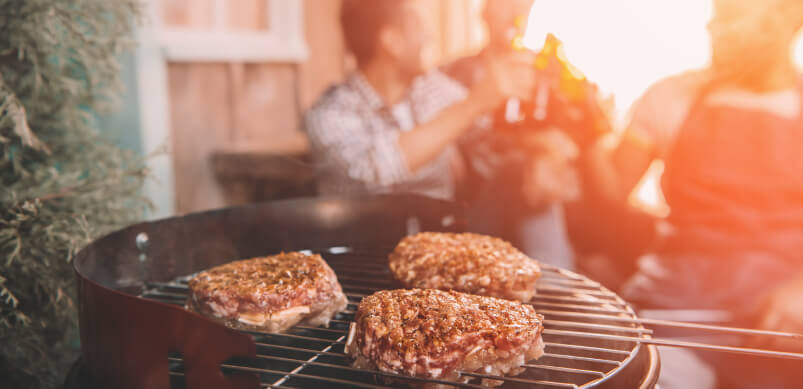 Men Drinking While Barbecue Is On